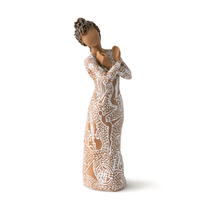 darker skinned, figurine posed with her arms crossed in front of her, palms open, facing each other